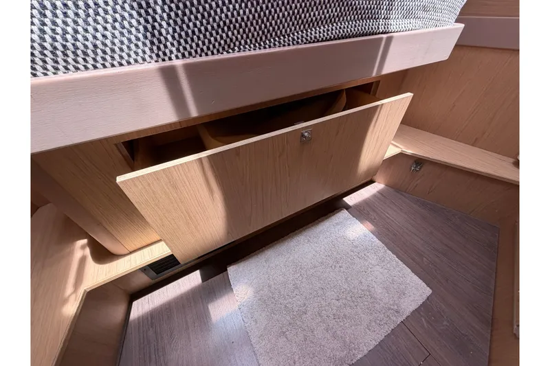 Slide: The Image of Interior view of 2017 Beneteau Oceanis 45 yacht with open wooden storage compartment. - 40