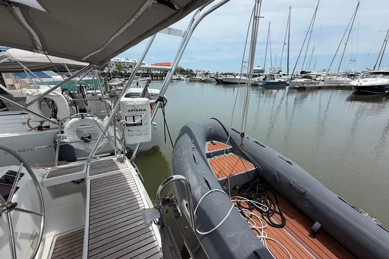 Slide: The Image of Beneteau Oceanis 45 sailboat docked with inflatable dinghy, marina view, 2017 model. - 25