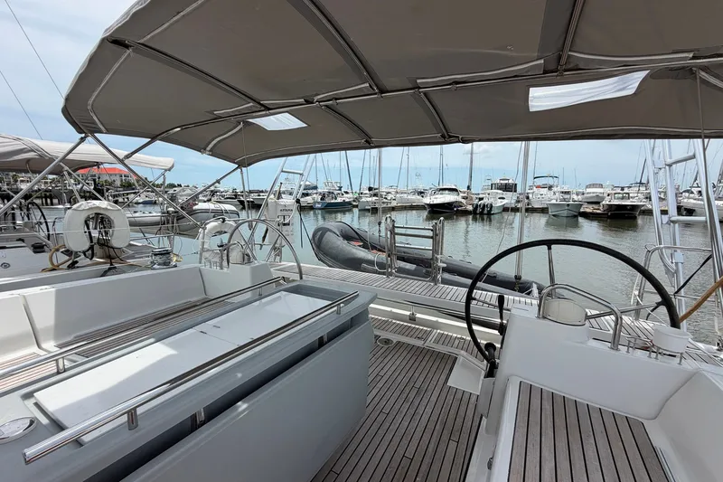 Slide: The Image of 2017 Beneteau Oceanis 45 yacht docked at marina, featuring dual steering wheels. - 23