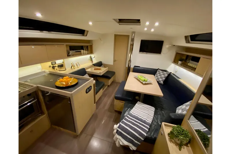 Slide: The Image of Interior of 2017 Beneteau Oceanis 45 yacht with modern kitchen and cozy seating area. - 32