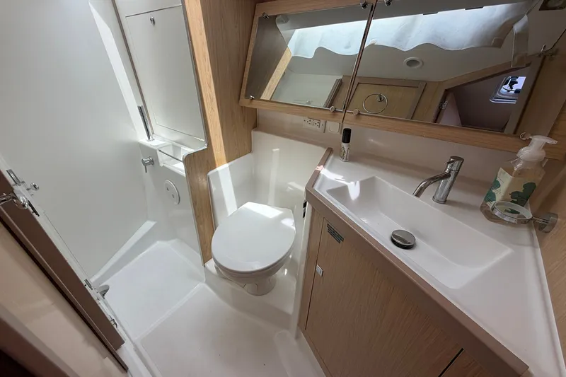 Slide: The Image of Modern bathroom in a 2017 Beneteau Oceanis 45 yacht, featuring sleek fixtures and wood accents. - 46