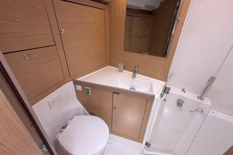 Slide: The Image of Modern bathroom in a 2017 Beneteau Oceanis 45 yacht with wood cabinetry. - 40