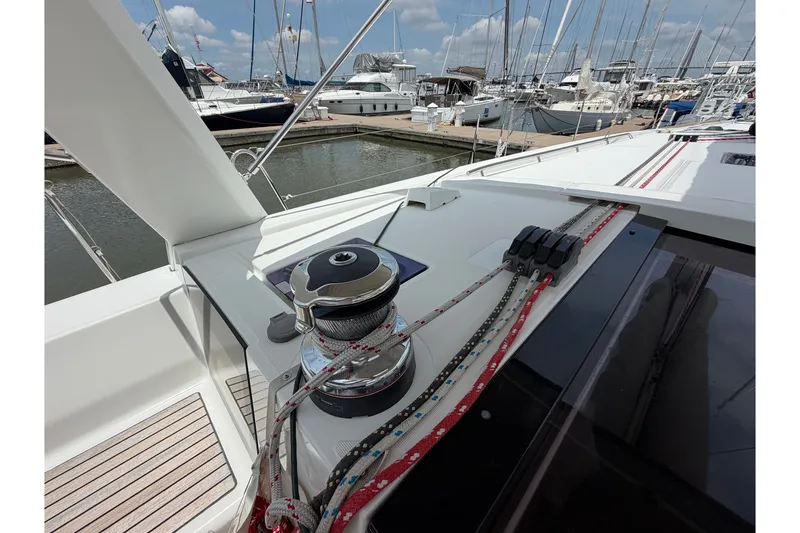 Slide: The Image of 2017 Beneteau Oceanis 45 yacht deck with winch and ropes in marina setting. - 18