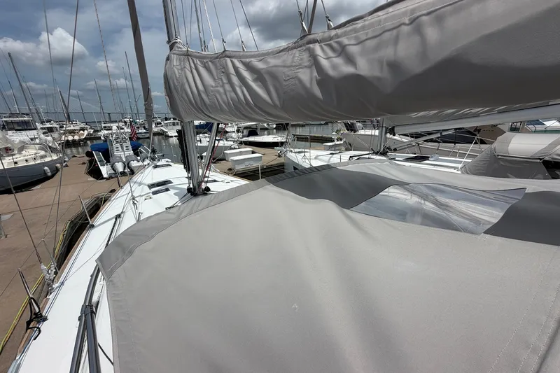 Slide: The Image of Beneteau Oceanis 45 sailboat, 2017 model, docked at a marina under a cloudy sky. - 31