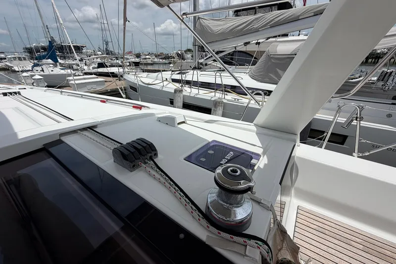 Slide: The Image of Beneteau Oceanis 45 sailboat deck, 2017 model, docked in a marina with other boats. - 19