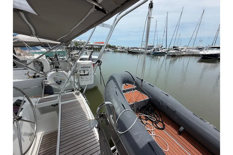 Slide: The Image of Beneteau Oceanis 45 sailboat, 2017 model, docked with inflatable dinghy, marina view. - 23