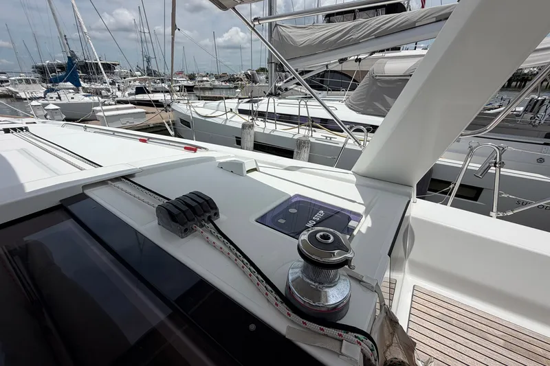 Slide: The Image of Beneteau Oceanis 45 sailboat deck, 2017 model, docked at marina with other boats. - 20