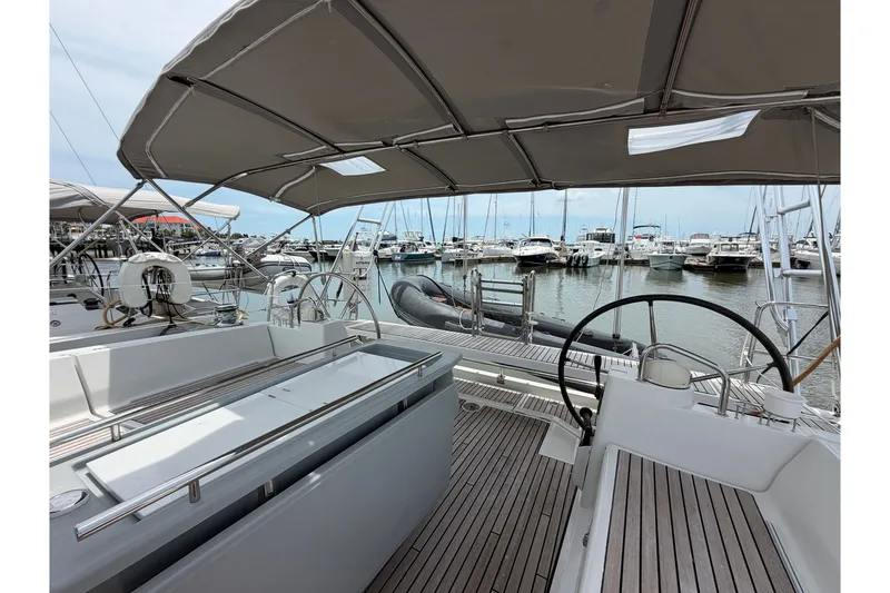 Slide: The Image of 2017 Beneteau Oceanis 45 yacht cockpit with dual steering wheels, docked at marina. - 22
