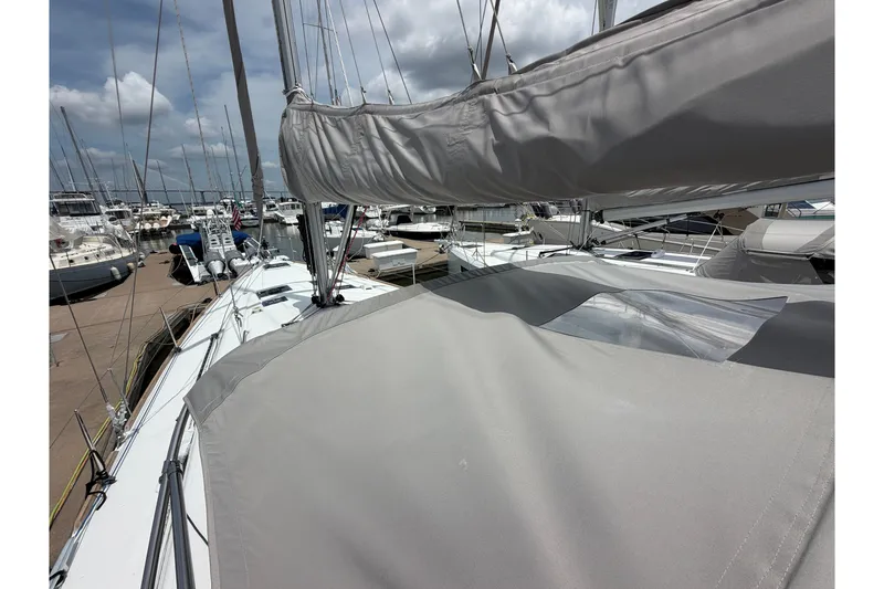 Slide: The Image of 2017 Beneteau Oceanis 45 sailboat docked at a marina under cloudy skies. - 28