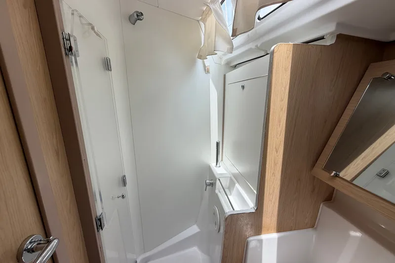 Slide: The Image of Interior of 2017 Beneteau Oceanis 45 yacht bathroom with modern fixtures and wood accents. - 47