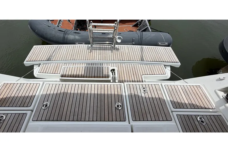 Slide: The Image of Beneteau Oceanis 45 (2017) yacht deck with wooden finish and ladder. - 24