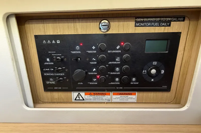 Slide: The Image of Control panel of a 2017 Beneteau Oceanis 45 sailboat with various switches and warnings. - 59