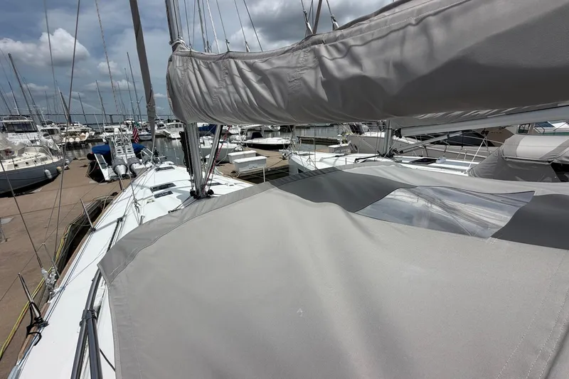 Slide: The Image of Beneteau Oceanis 45 sailboat, 2017 model, docked at a marina under a cloudy sky. - 30