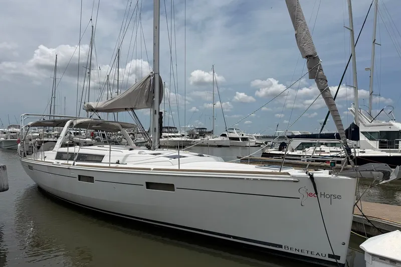 The Image of 2017 Beneteau Oceanis 45 sailboat docked at marina under cloudy sky. - 1