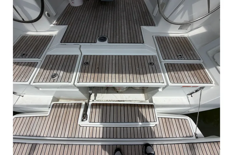 Slide: The Image of Beneteau Oceanis 45 (2017) yacht deck with teak flooring and storage compartments. - 25
