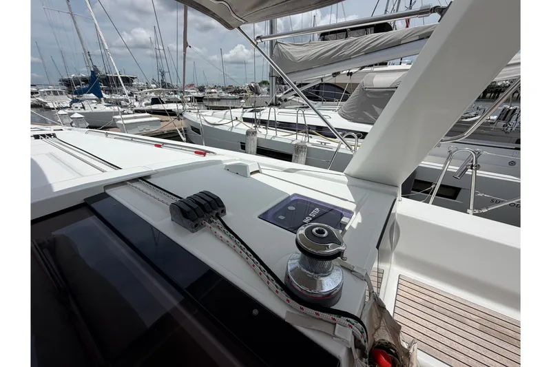 Slide: The Image of Deck view of a 2017 Beneteau Oceanis 45 sailboat in a marina setting. - 19