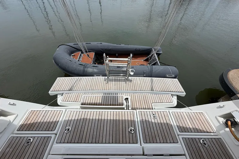 Slide: The Image of Beneteau Oceanis 45 yacht stern with wooden deck and inflatable dinghy, 2017 model. - 26