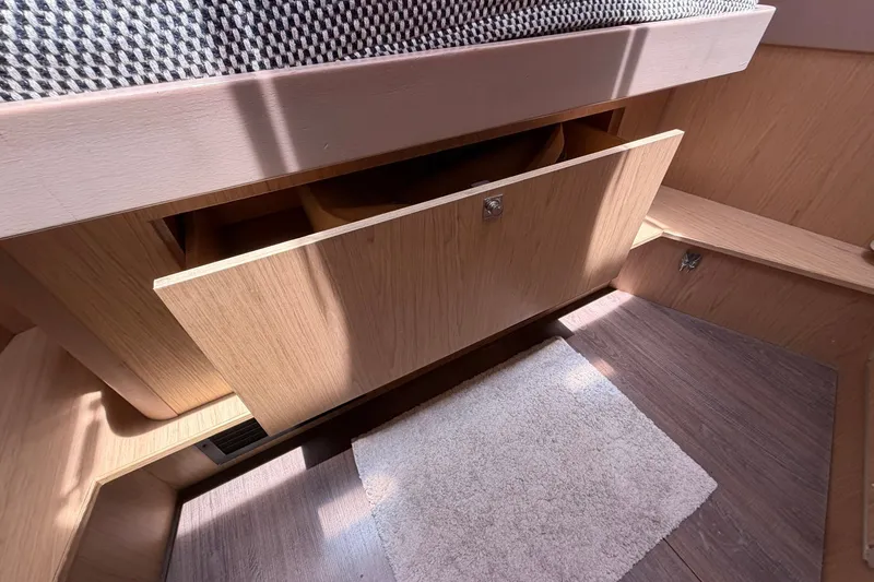 Slide: The Image of Interior of 2017 Beneteau Oceanis 45 yacht with open wooden storage compartment. - 43