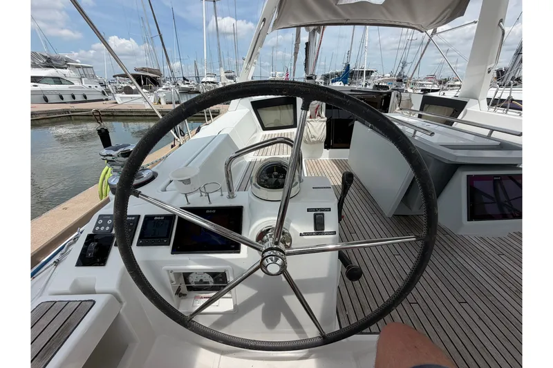 Slide: The Image of Steering wheel of a 2017 Beneteau Oceanis 45 yacht at a marina. - 26