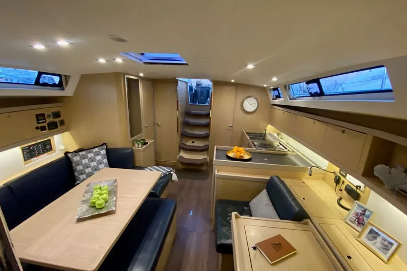 Slide: The Image of Luxurious interior of 2017 Beneteau Oceanis 45 yacht with modern kitchen and dining area. - 32