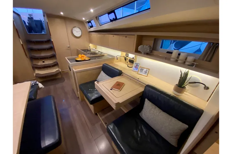 Slide: The Image of Interior of 2017 Beneteau Oceanis 45 yacht with modern seating and kitchen area. - 33