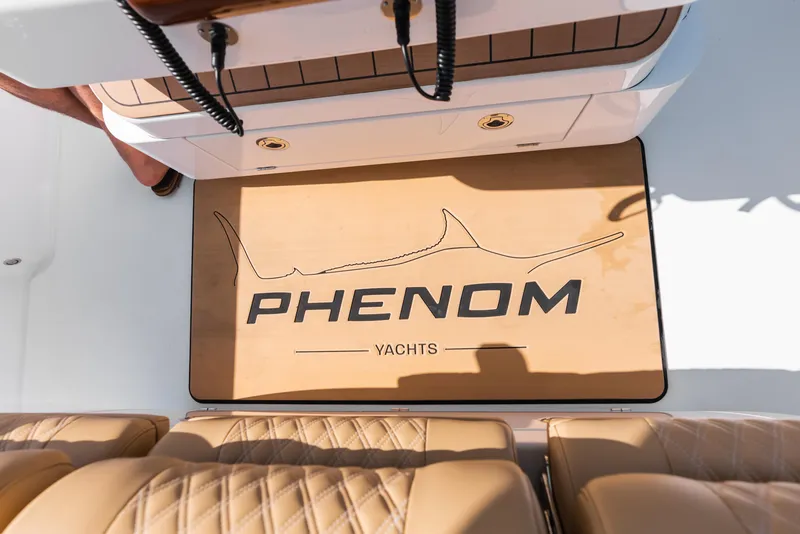 Slide: The Image of 2026 Phenom 34 Center Console yacht interior with branded mat and leather seating. - 11