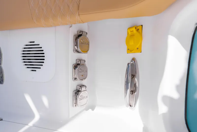 Slide: The Image of 2026 Phenom 34 Center Console boat interior with speaker, power outlets, and yellow switch. - 19