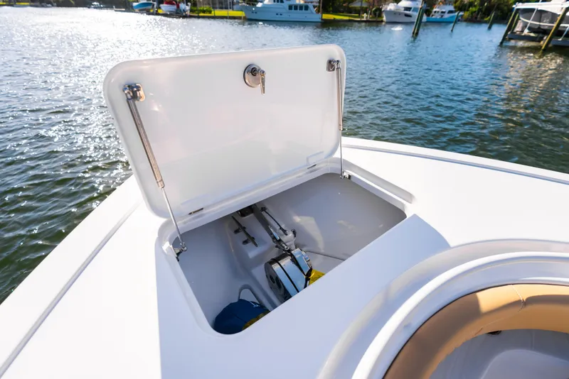 Slide: The Image of Open storage compartment on 2026 Phenom 34 Center Console boat, docked by the water. - 28