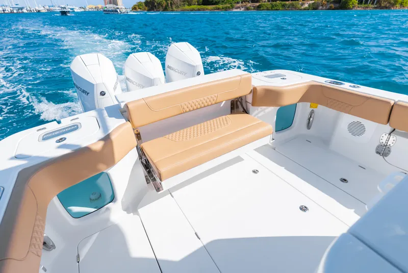 Slide: The Image of 2026 Phenom 34 Center Console boat with tan seating and triple Mercury engines on blue water. - 12
