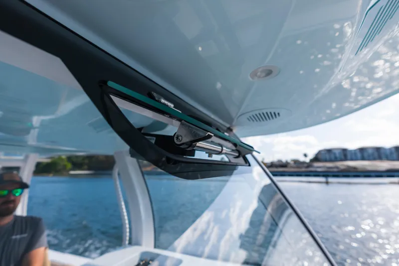 Slide: The Image of Close-up of 2026 Phenom 34 Center Console boat windshield and wiper system. - 8