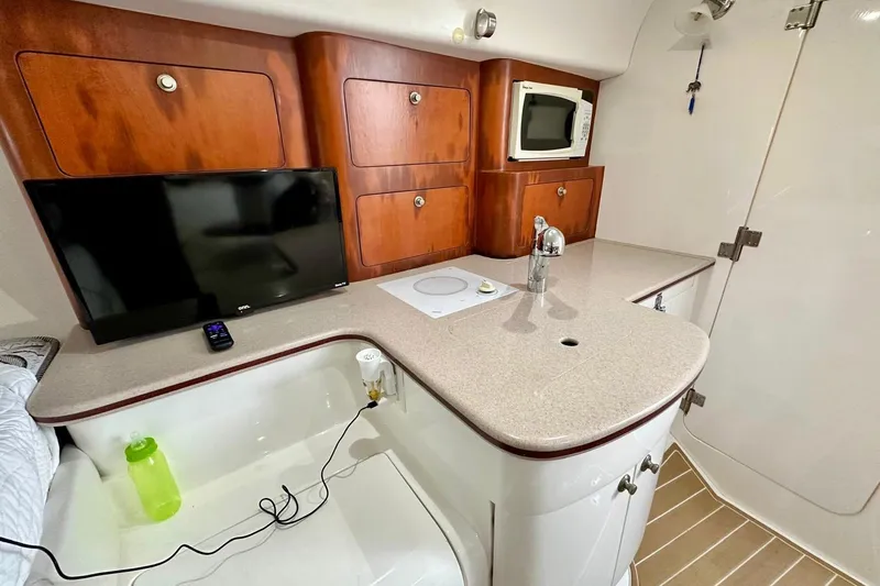 Slide: The Image of Interior of 2006 Intrepid 377 Walkaround with kitchenette, TV, and microwave. - 23