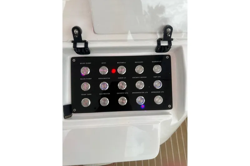 Slide: The Image of Control panel of a 2006 Intrepid 377 Walkaround boat with labeled switches. - 17