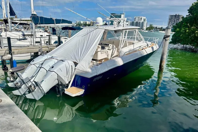 Slide: The Image of 2006 Intrepid 377 Walkaround boat docked with triple Mercury outboard engines. - 3
