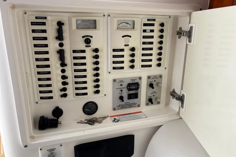 Slide: The Image of Electrical control panel on a 2006 Intrepid 377 Walkaround boat, featuring various switches and gauges. - 25