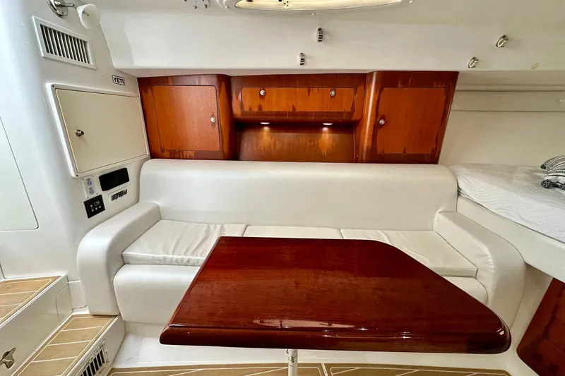 Slide: The Image of Interior of 2006 Intrepid 377 Walkaround with white seating and wooden cabinetry. - 22