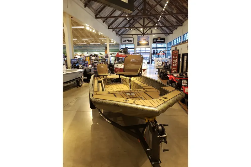 The Image of 2026 Tracker Grizzly 1756 T Marsh boat displayed in a showroom. - 0
