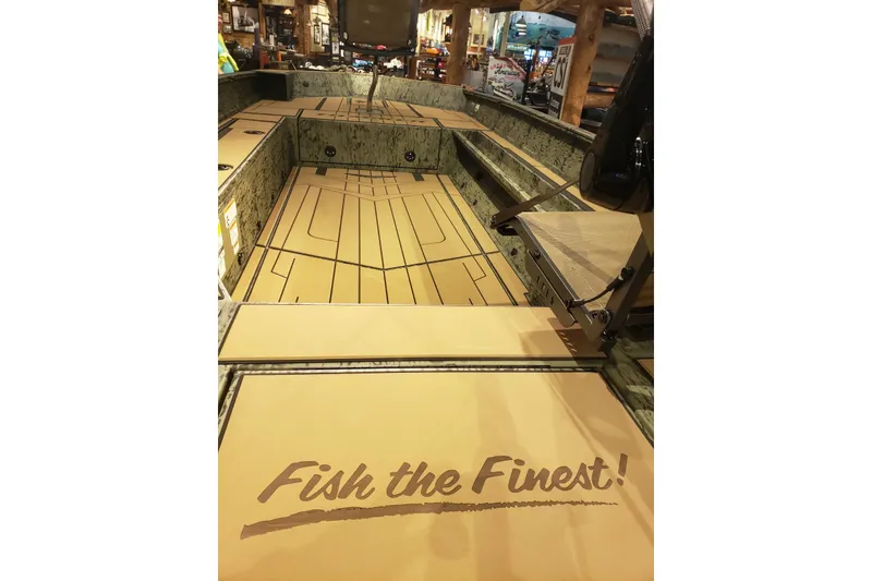 Slide: The Image of 2026 Tracker Grizzly 1756 T Marsh boat interior with "Fish the Finest!" slogan. - 7