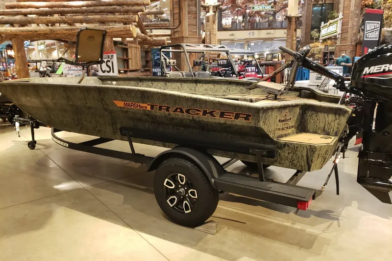 Slide: The Image of 2026 Tracker Grizzly 1756 T Marsh boat displayed indoors on a trailer. - 3