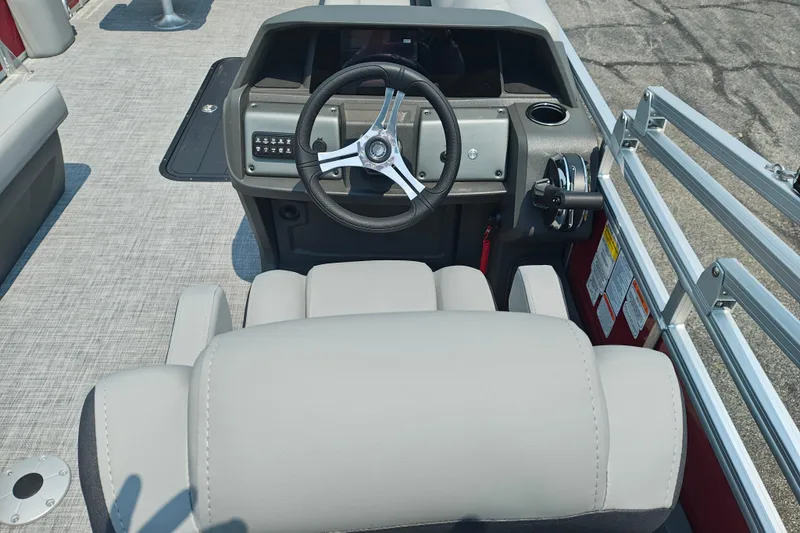 Slide: The Image of 2026 Sun Tracker Sportfish 24 XP3 boat helm with steering wheel and control panel. - 11