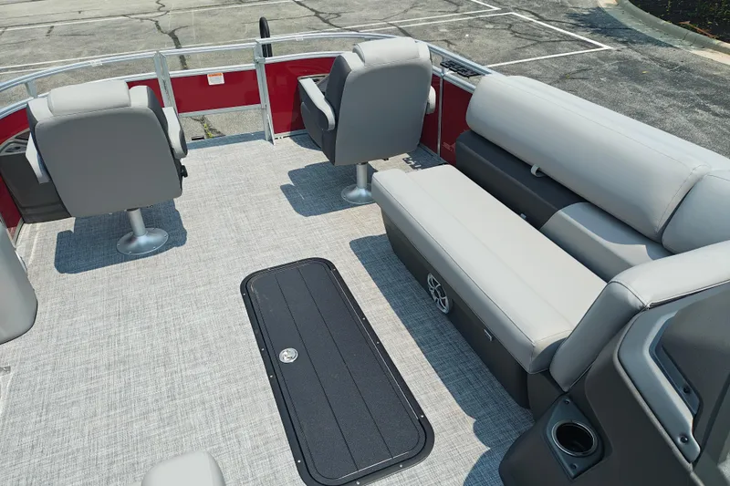Slide: The Image of 2026 Sun Tracker Sportfish 24 XP3 interior with gray seating and carpeted flooring. - 23