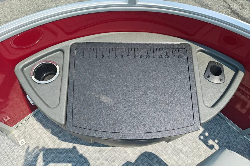 Slide: The Image of 2026 Sun Tracker Sportfish 24 XP3 boat console with cup holders and measuring board. - 28