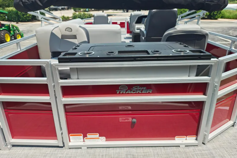 Slide: The Image of 2026 Sun Tracker Sportfish 24 XP3 pontoon boat with red exterior and seating area. - 20
