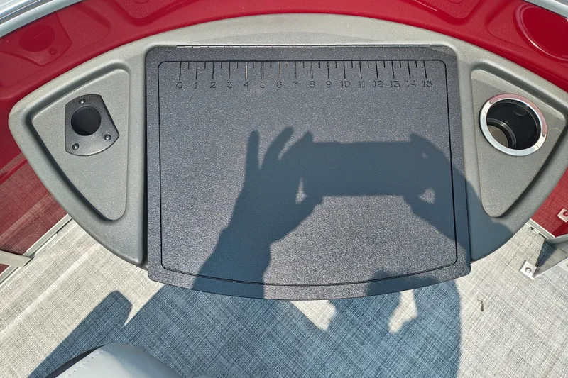 Slide: The Image of 2026 Sun Tracker Sportfish 24 XP3 boat console with cup holders and measuring board. - 27