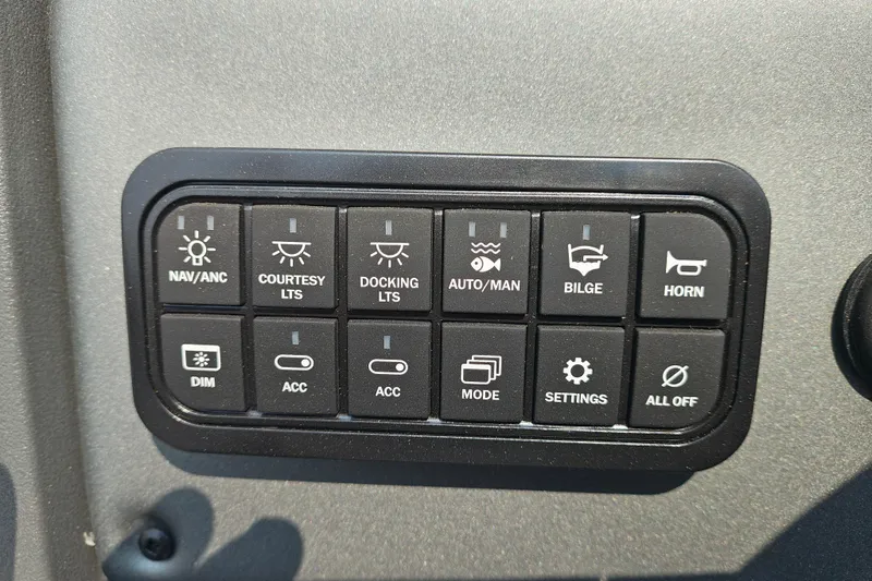 Slide: The Image of Control panel of 2026 Sun Tracker Sportfish 24 XP3 with various function buttons. - 12