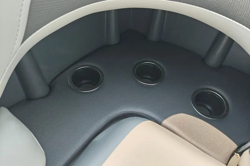 Slide: The Image of 2026 Sun Tracker Sportfish 24 XP3 boat interior with three cup holders. - 9