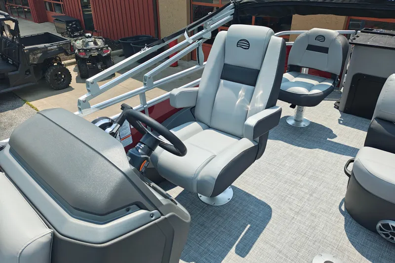 Slide: The Image of 2026 Sun Tracker Sportfish 24 XP3 boat interior with modern seating and steering console. - 7