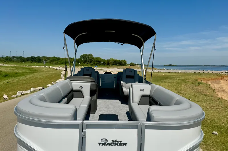 Slide: The Image of 2026 Sun Tracker Party Barge 24 XP3 pontoon boat on a scenic lakeside. - 3