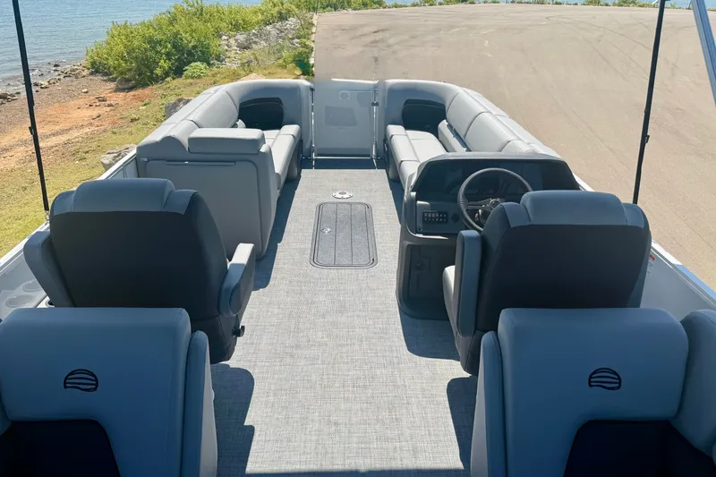 Slide: The Image of Interior view of 2026 Sun Tracker Party Barge 24 XP3 pontoon boat with seating and steering wheel. - 5