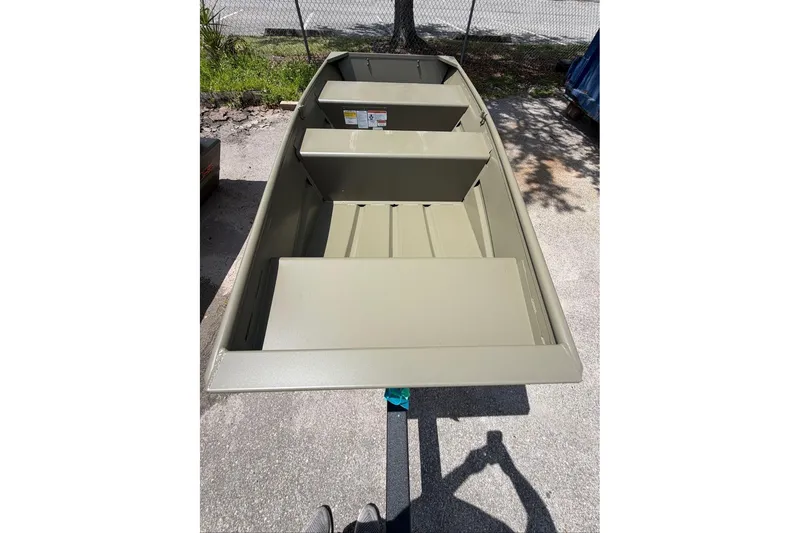 The Image of 2026 Tracker Grizzly 10 Jon boat on trailer, parked outdoors in sunlight. - 0