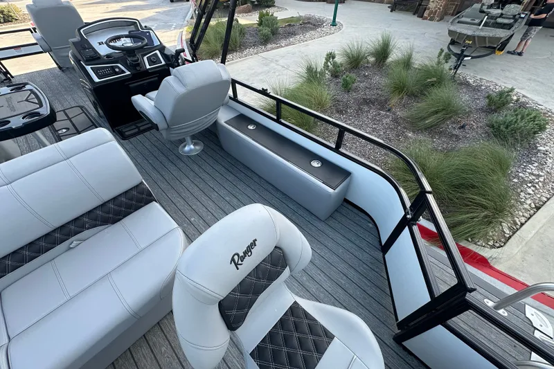 Slide: The Image of Interior of 2026 Ranger 223F boat with modern seating and steering console. - 78